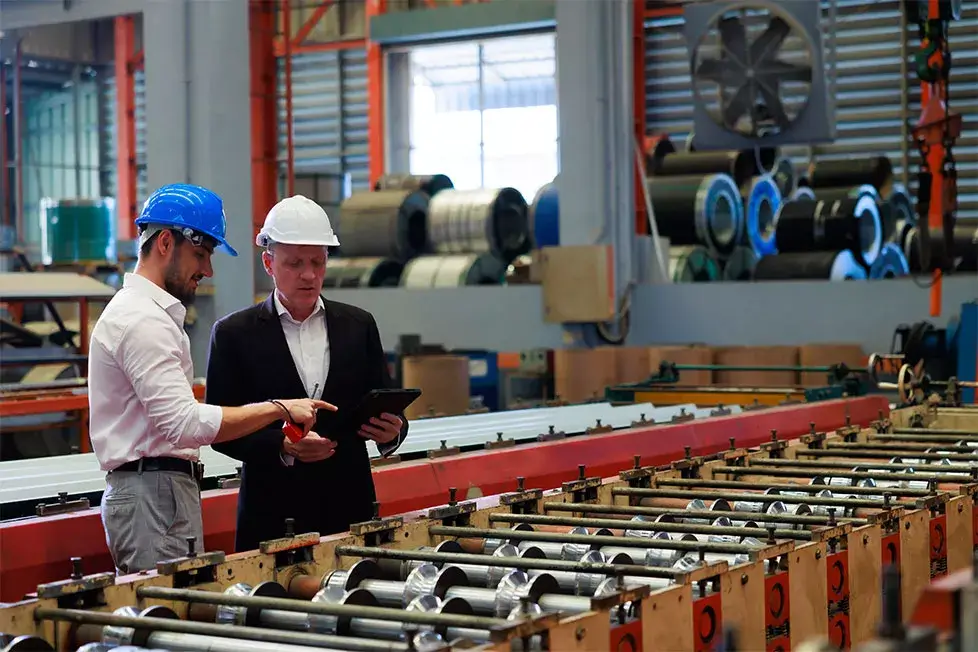 Factory managers reviewing commercial solar PV plans eligible under the Accelerated Capital Allowance scheme in Ireland