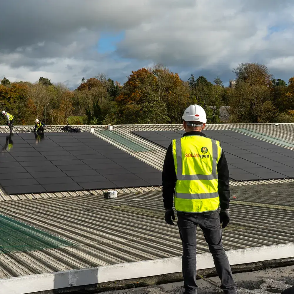 Sean Harnett Standing on Primus POD High Spec Manufacturing rooftop during Solar Panel Installation
