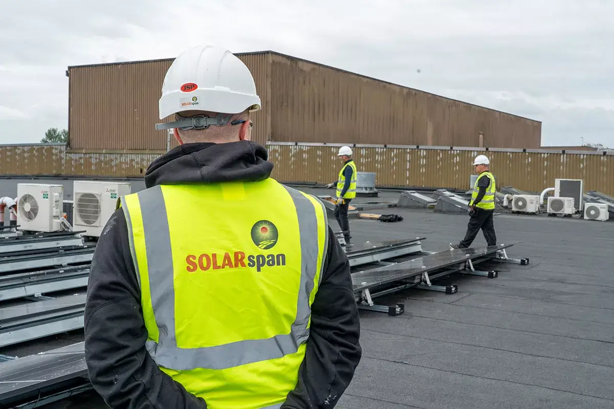 SOLARspan installation team standing on a commercial rooftop during a Commercial Solar PV project, reflecting the expertise of best solar panel installers in Ireland working for top rated best solar pv companies